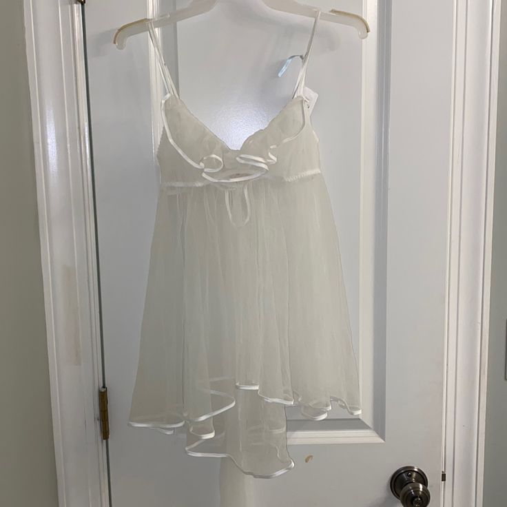 Victoria’s Secret “I Do” Collection Sheer Chemise Slip! Completely See Through, Never Been Worn, Nwt! Perfect Condition! Has A Stunning Silhouette, With A Longer Back And Tulle Bow On The Back! Gorgeous Piece. Size Medium But Could Fit Xs-M! Victoria's Secret White Camisole Sleepwear, Sheer White Loungewear Tops, White Sheer Tops For Loungewear, Fitted White Victoria's Secret Sleepwear, White Sheer Sleep Camisole, White Sheer Camisole For Sleep, White Victoria's Secret Camisole For Loungewear, Victoria's Secret White Sleeveless Sleepwear, Victoria's Secret White Lace Sleepwear