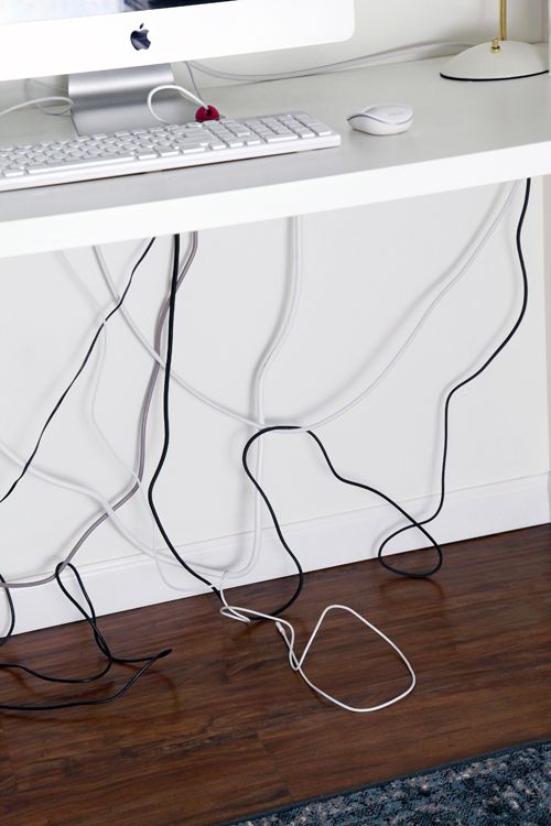 a computer monitor sitting on top of a white desk next to a keyboard and mouse