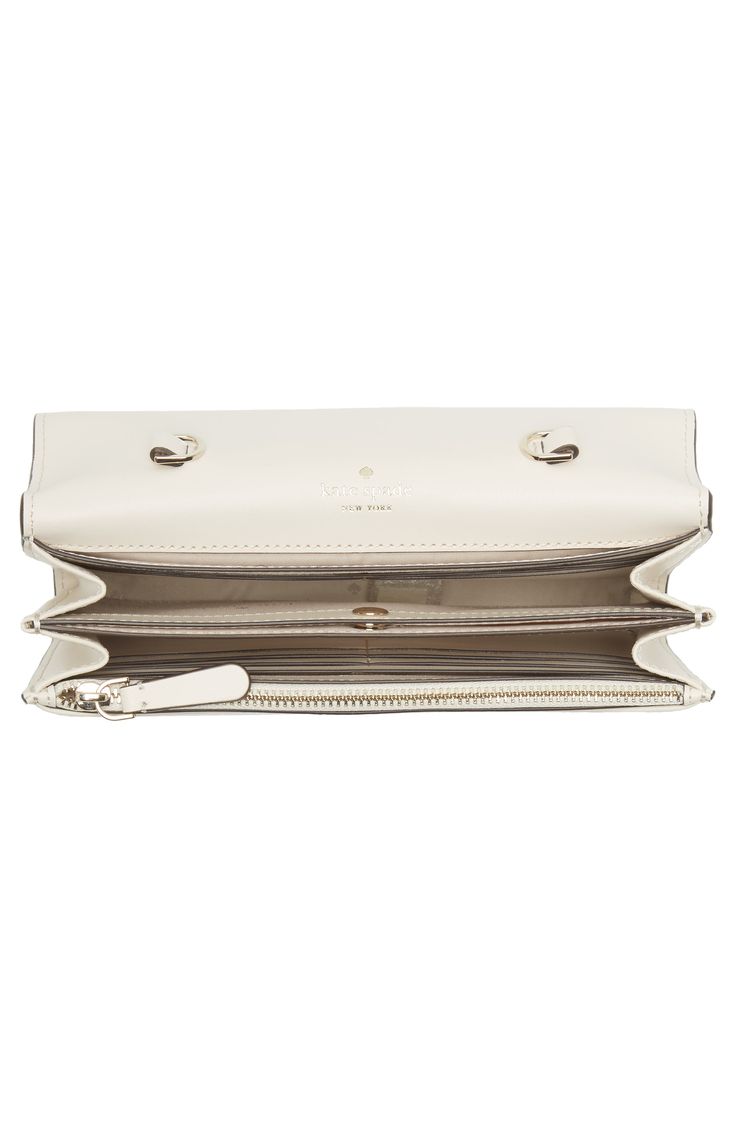 Gleaming hardware and lightly textured leather lend contemporary sophistication to a clutch-sized wallet outfitted with a detachable crossbody strap. 9"W x 6"H x 2"D 20" strap drop Magnetic-snap flap closure Removable crossbody strap Structured silhouette with flat base for stability Synthetic Imported Kate Spade White Leather Wallet, Kate Spade Travel Wallets With Zipper, Kate Spade Travel Wallet With Zipper Closure, Kate Spade Wallet Kate Spade New York, Wristlet Wallet Kate Spade New York, Kate Spade Wallets With Zipper Closure, Nordstrom Rack, Kate Spade New York, Kate Spade