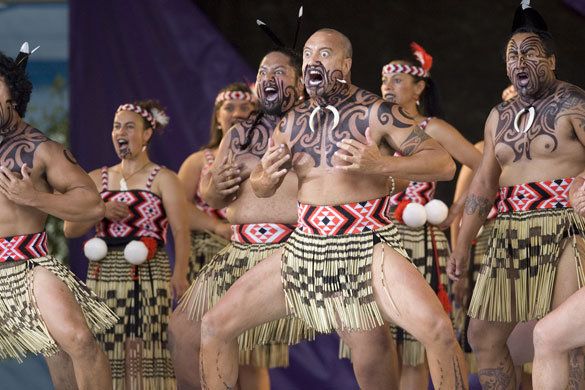 some people are dancing and having tattoos on their bodies in the middle of a performance