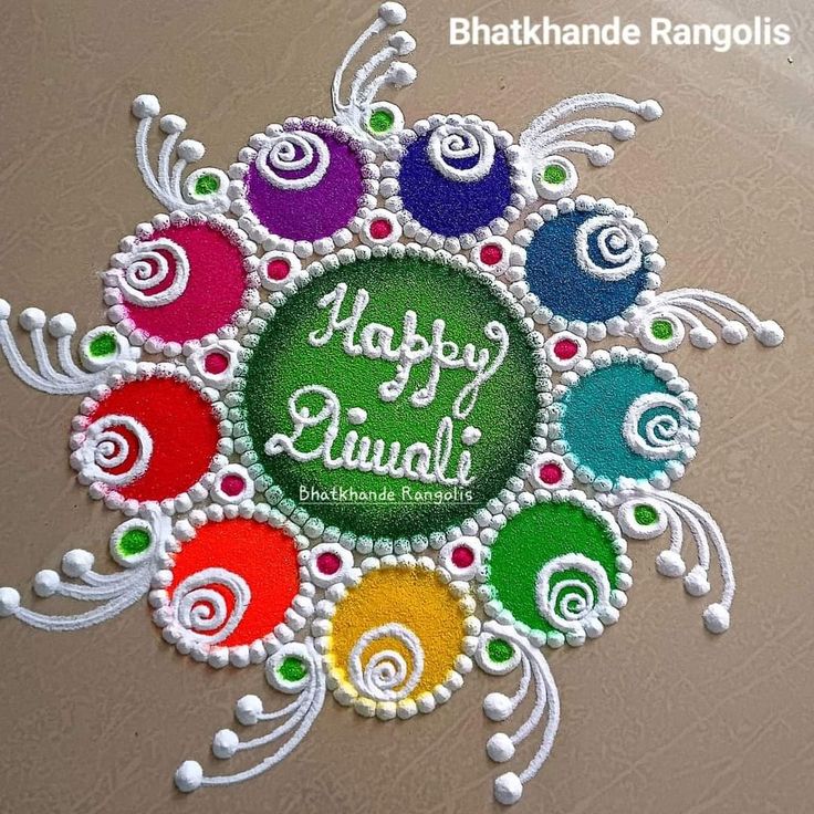 a colorful rangoli design with the words happy diwali written in white and green