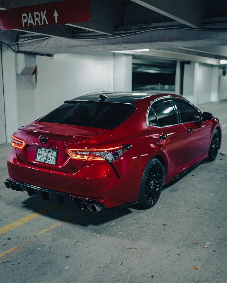 a red car parked in a parking garage