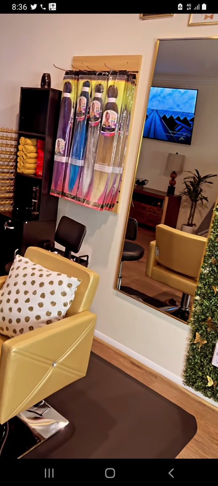 a hair salon with christmas tree in the corner and mirror on the wall behind it