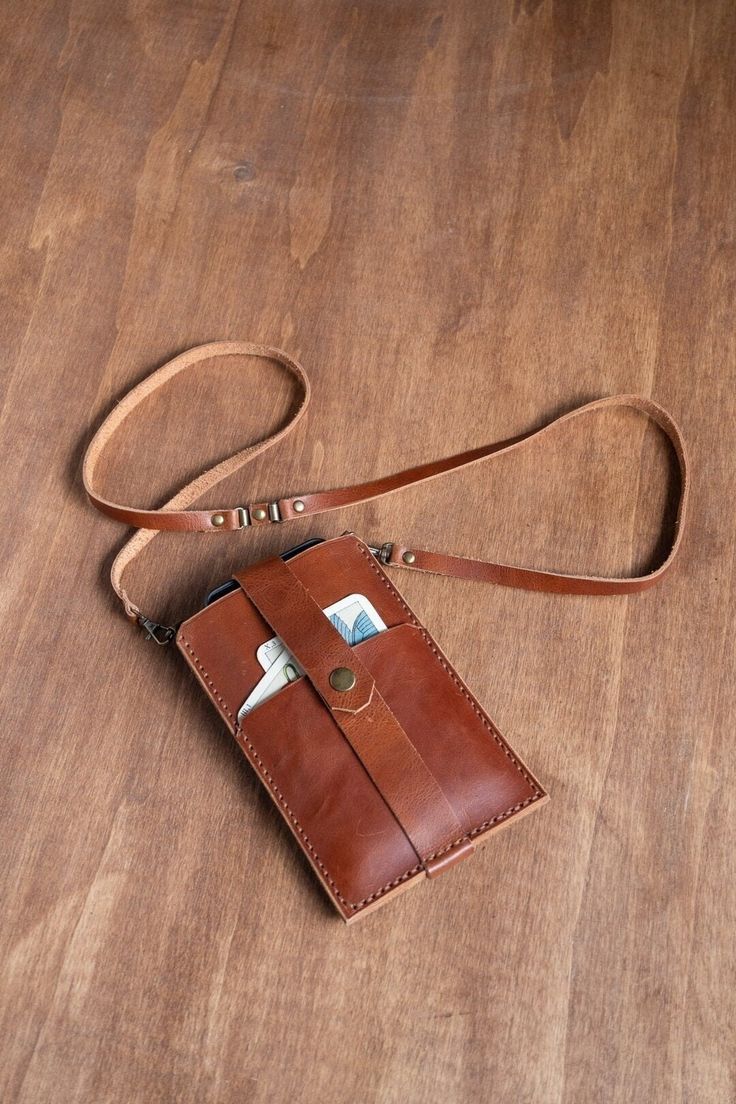 a brown leather purse sitting on top of a wooden floor