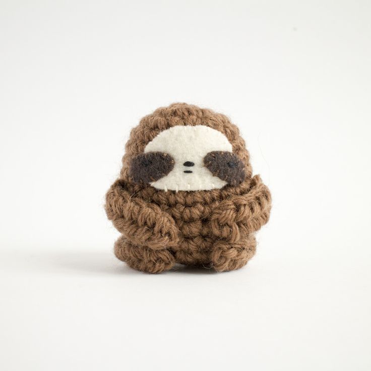 a crocheted stuffed slotty sitting on top of a white surface