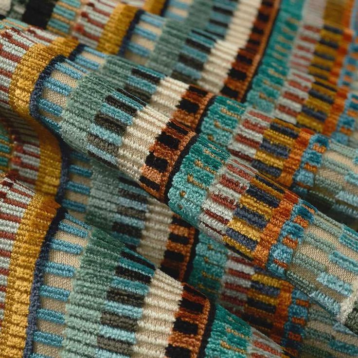 multicolored knitted fabric close up on top of each other with vertical stripes