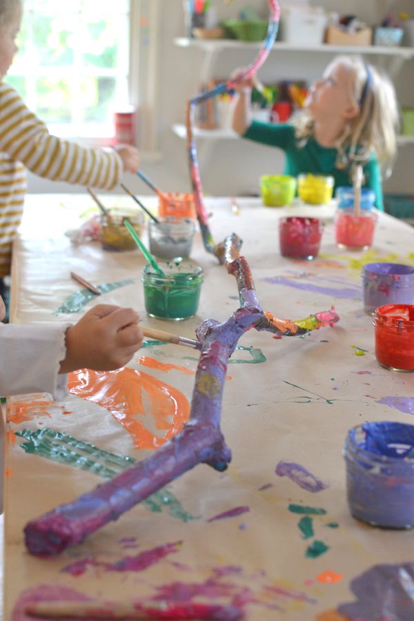 two children are painting with their hands on the table