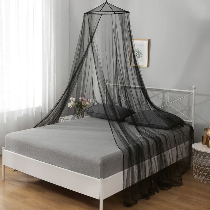 a bed with a black mosquito net over it