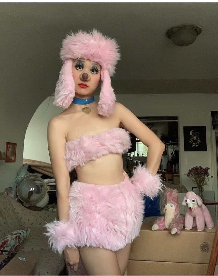 a mannequin dressed in pink fur with poodles on it's head