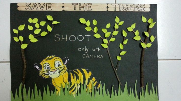 a paper cut out of a tiger with trees on it's side and the words save the tigers