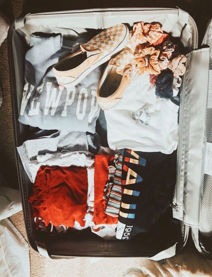 an open suitcase filled with clothes and shoes