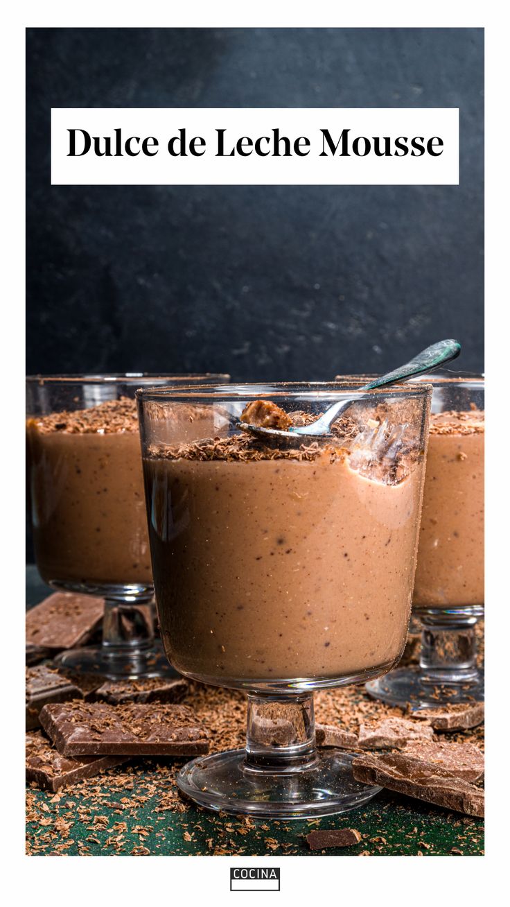 three glasses filled with dessert on top of a table