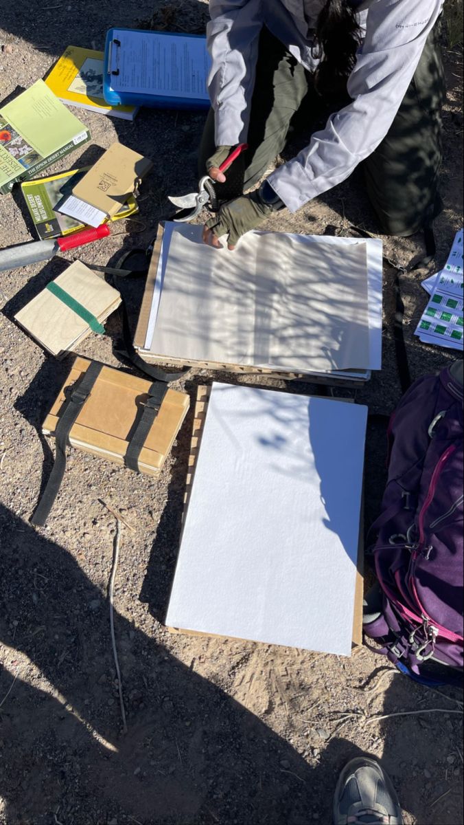 a person standing over some papers on the ground