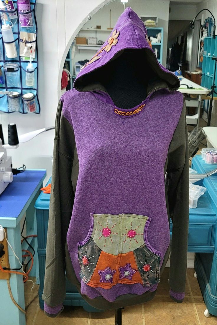 a mannequin wearing a purple and black hoodie