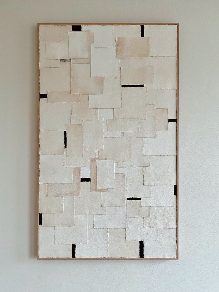 a white and black painting hanging on the wall