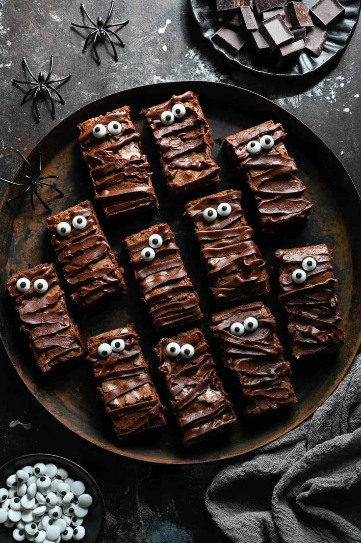 chocolate brownies decorated with googly eyes on a plate