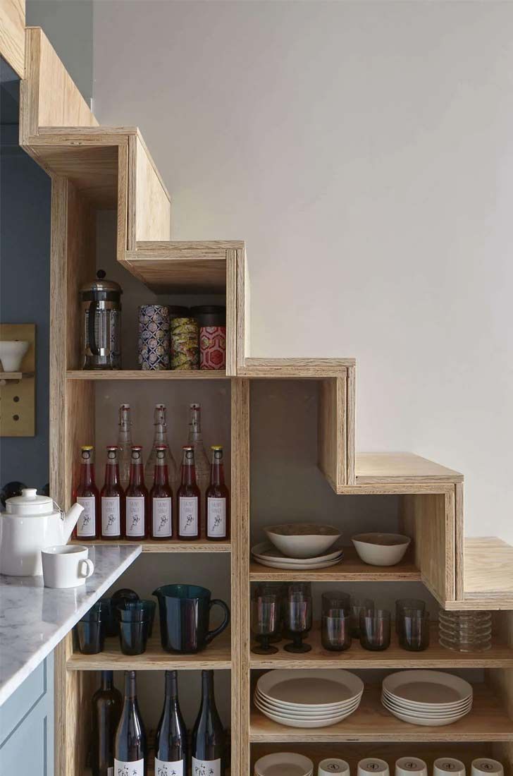 the shelves in this kitchen are filled with wine bottles and other things to drink from