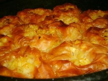 a close up of food in a pan on a stove