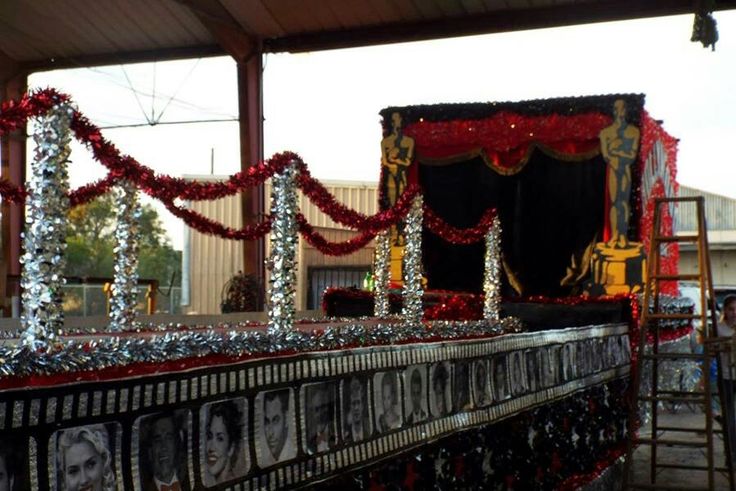 an elaborately decorated train car with pictures on it's sides and decorations around the edges