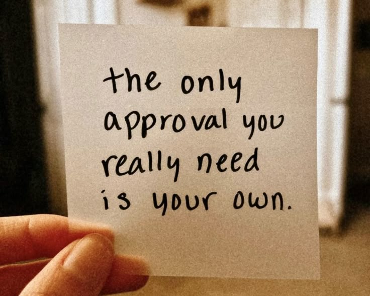 someone holding up a piece of paper that says the only approval you really need is your own