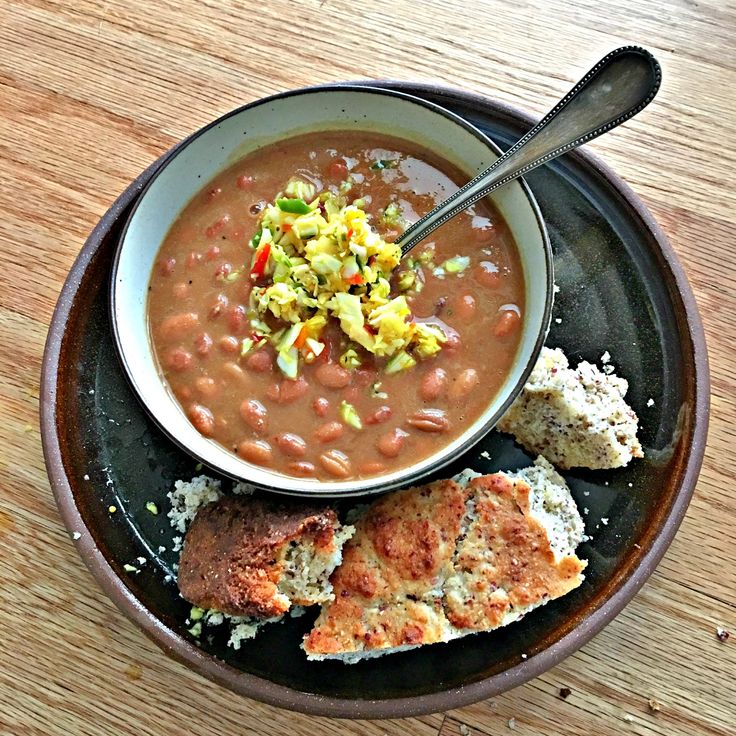 a bowl of soup and two pieces of bread on a plate