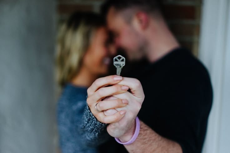 a close up of a person holding a key