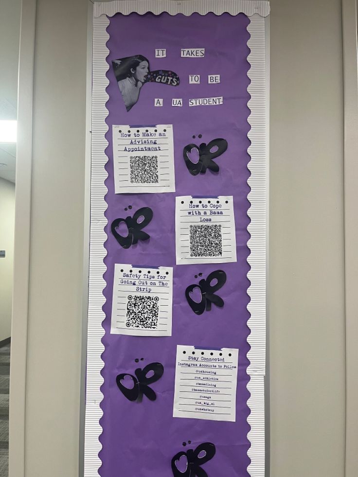 a purple bulletin board with black and white paper cutouts on it, along with qr code tags