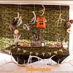 the table is decorated with deer antlers and balloons