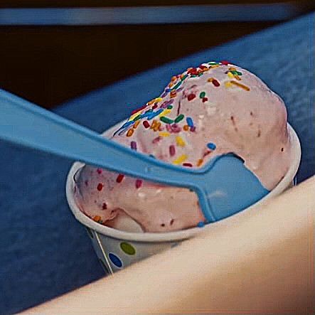 an ice cream sundae with sprinkles in a plastic cup