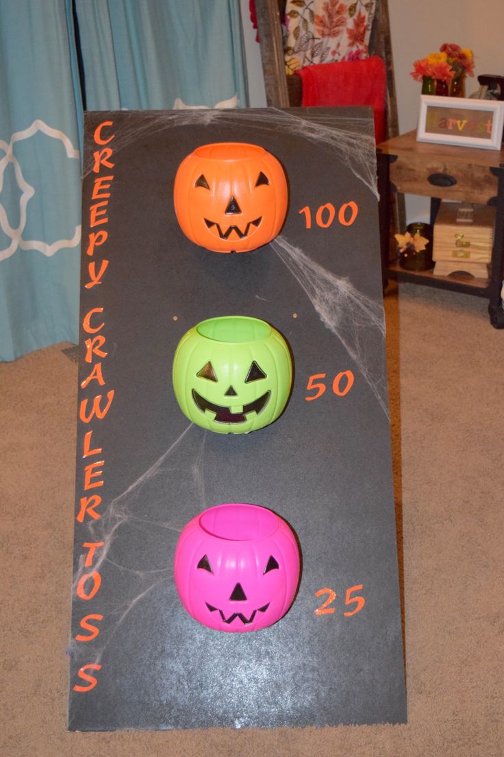 three pumpkins and two jack - o'- lantern faces on a black surface