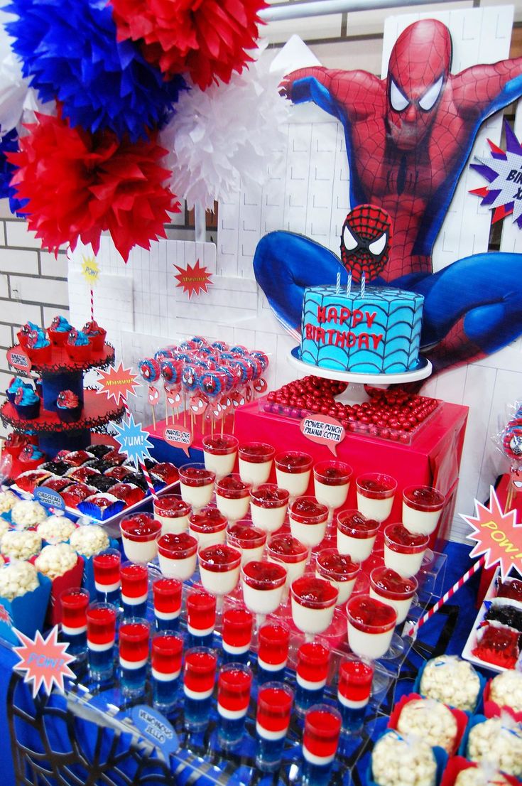 a spiderman themed birthday party with cupcakes and cake