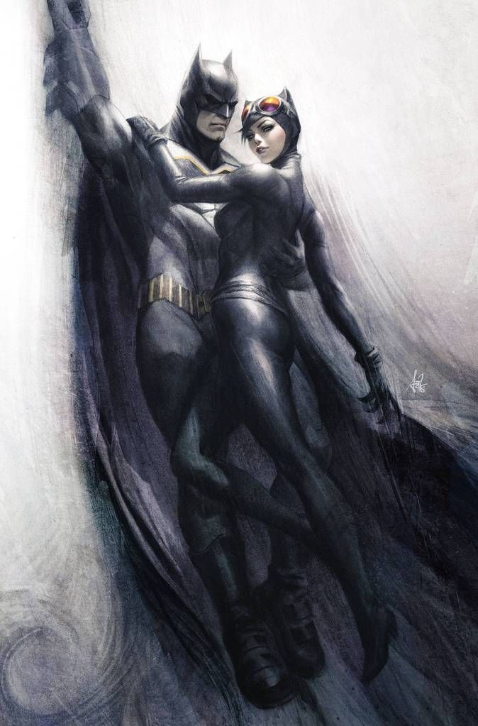 the batman and catwoman are hugging each other