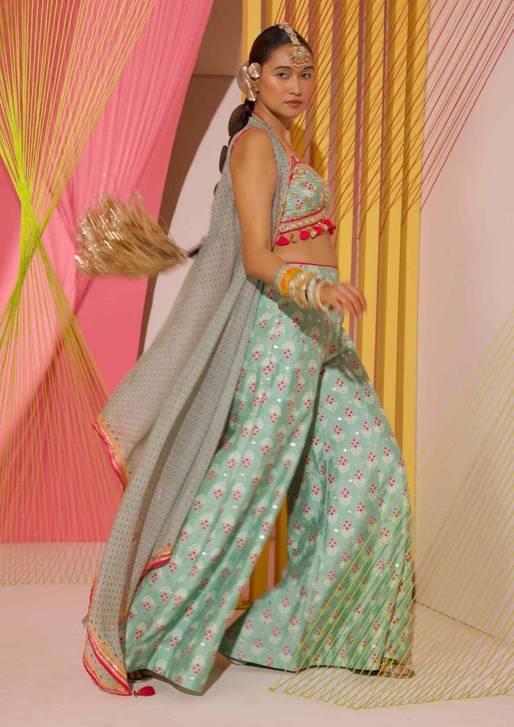 Editor's Note Step into the world of contemporary fashion with these gorgeous coordinate printed panel pants. The vibrant mix of strong floral butta and geometric jaal, delicately enhanced with... Cape Organza, Gopi Vaid, Blouse Yoke, Indian Arts And Crafts, Beach Wedding Guests, Long Cape, Blazer Set, Green Floral Print, Couture Designers