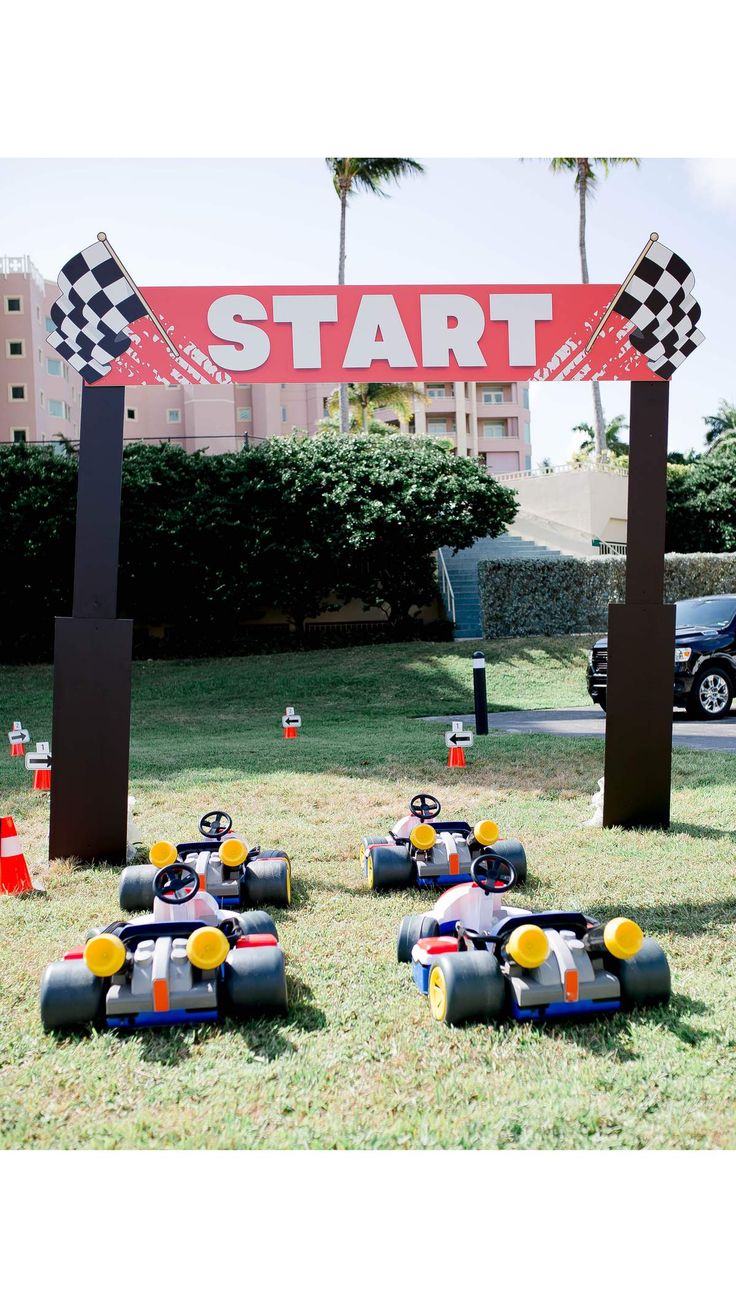 race cars are lined up in front of a start sign