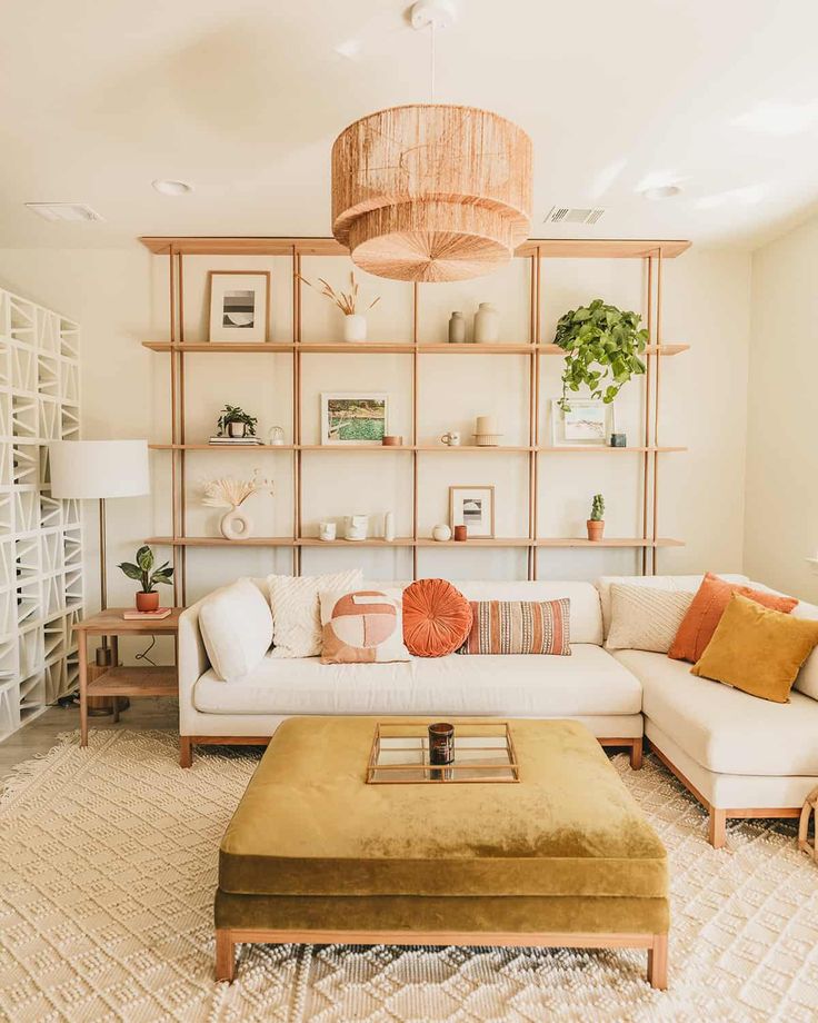 a living room filled with lots of furniture and decor on top of a white rug