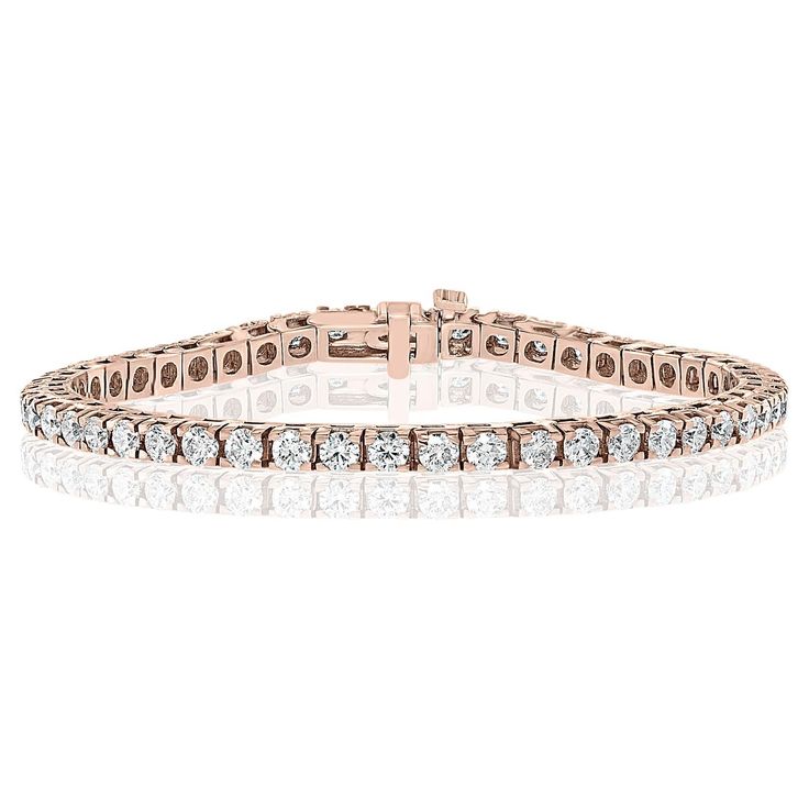 A classic tennis bracelet style showcasing a row of round brilliant diamonds, set in a polished 14k rose gold mounting. Diamonds weigh 4.01 carats total and are approximately GH color, SI1 clarity. Style is available in different price ranges. Prices are based on your selection of the 4C’s (Carat, Color, Clarity, Cut). Don't hesitate to get in touch with us for more information. Bracelet Tennis, American Modern, Tennis Bracelet Diamond, Brilliant Diamond, Tennis Bracelet, Round Brilliant, Fashion Bracelets, Or Rose, Round Diamonds