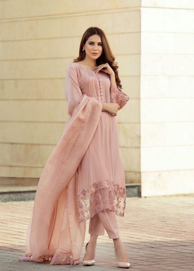 Blush pink pure crepe silk shirt with details on the neckline and embroidery and embellishments on the sleeves and bottom of the shirt. Paired with matching skinny shalwar (Includes shirt and skinny shalwar) Pink Dabka Work Kurta For Party Wear, Pink Cotton Silk Lawn Suit With Dabka Detailing, Elegant Pink Lawn Suit With Dabka Work, Anarkali Georgette Kurta With Embroidered Sleeves, Pink Sets With Embroidered Sleeves For Wedding, Elegant Pink Churidar With Chikankari Embroidery, Elegant Designer Pink Churidar, Pink Unstitched Salwar Kameez For Formal Occasions, Elegant Pink Semi-stitched Churidar