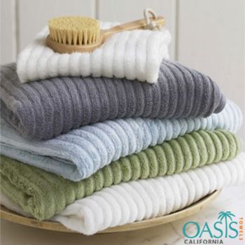 a pile of towels sitting on top of a wooden plate