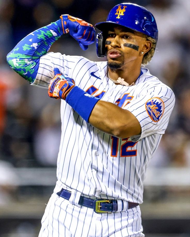 a baseball player is holding his glove up to his head while standing on the field