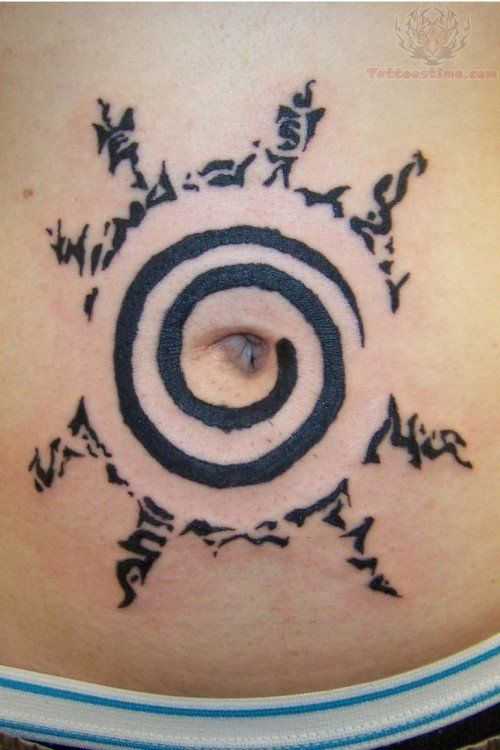 a woman's stomach with an abstract tattoo on it