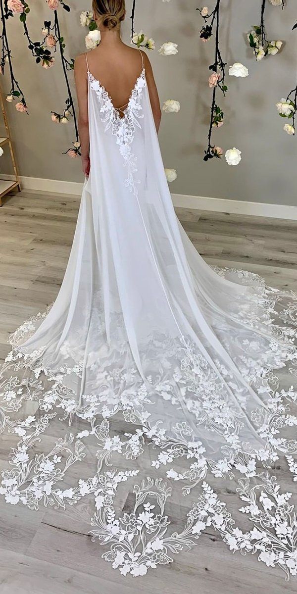 the back of a woman's wedding dress with flowers on it