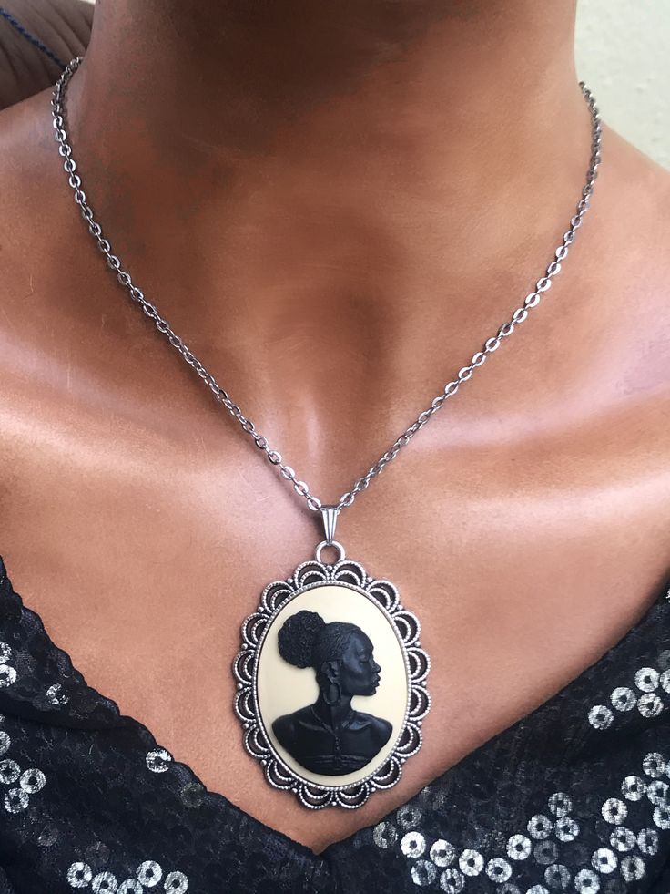 The last day to shop is December 13th. Black and Ivory Cameo Necklace for Women. Choose your cameo, Black, Ivory or Ivory and Blue. You also choose 16 or 18 inches long. From the Beloved collection celebrating African and African American heritage. This is a beautiful statement necklace. The pendant is 2 inches long and 1.75 inches wide. The piece is light and comfortable and nickel-free. This is the large pendant size available in this style. The other pendants sizes available in this style: Me African American Jewelry, Black Cameo, Cameo Jewelry, Jason Statham, Cameo Necklace, Pompano Beach, Fantasy Jewelry, American Heritage, American Jewelry