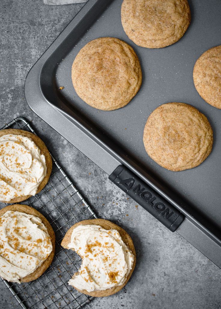 some cookies are cooling on a rack next to an electric grill with one cookie in it