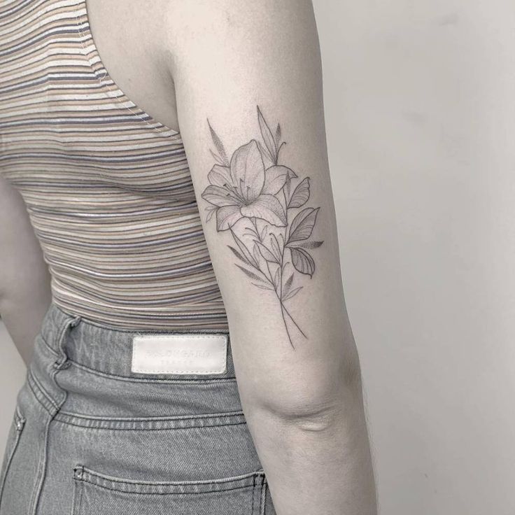 a woman with a flower tattoo on her arm