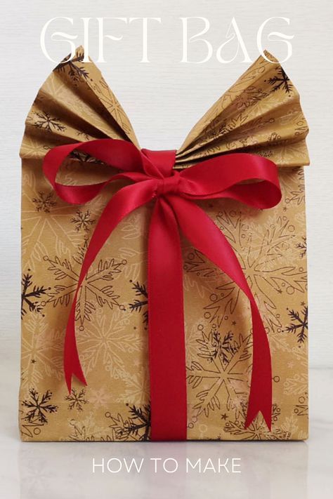 a gift bag with a red ribbon tied around it and the words how to make