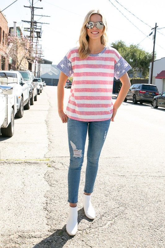 4TH OF JULY AMERICAN FLAG PRINT MIXED ROUND NECK SHORT SLEEVE TOP- MADE IN U.S.A. Style: CASUAL Print / Pattern: STRIPED Fit: REGULAR Neck Line: ROUND NECK Sleeve: SHORT SLEEVE Lining: NO Made In: Made In U.S.A Fabric Contents: 50% Polyester 38% Cotton 12% Rayon Non-sheer fabric Care Instructions: MACHINE WASH COLD, DO NOT BLEACH Casual Short Sleeve T-shirt With American Flag, Sporty Cotton Tops With American Flag Print, Patriotic American Flag Print Short Sleeve Top, Casual Red T-shirt With American Flag Print, Sporty Crew Neck Top With American Flag Print, American Style Cotton Tops With Flag Print, Americana Cotton Top With American Flag Print, Americana Style Cotton Tops With American Flag Print, Americana Style Cotton Top With American Flag Print