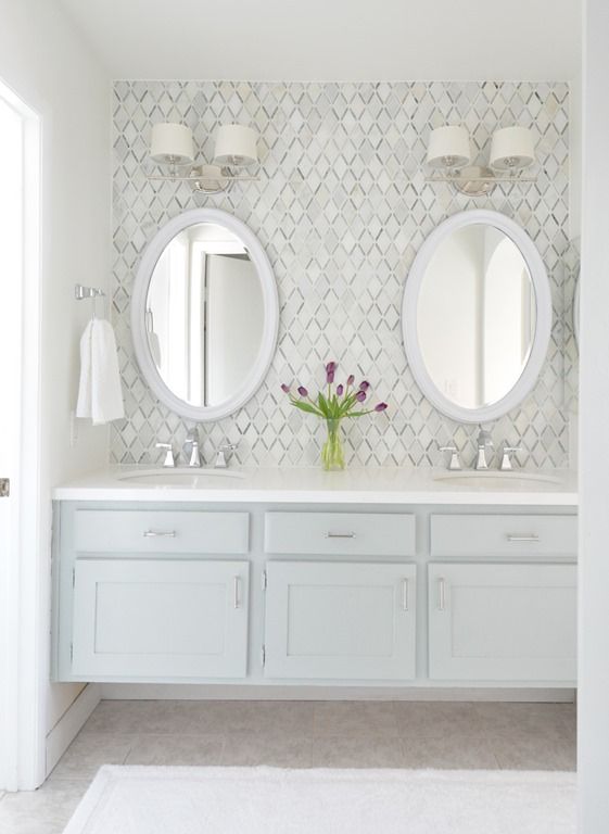 a white bathroom with two sinks and mirrors on the wall next to it is an instagram page