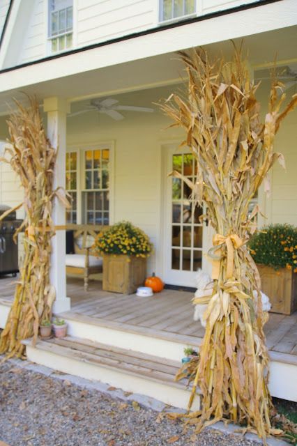 corn stalks on the front porch of a house