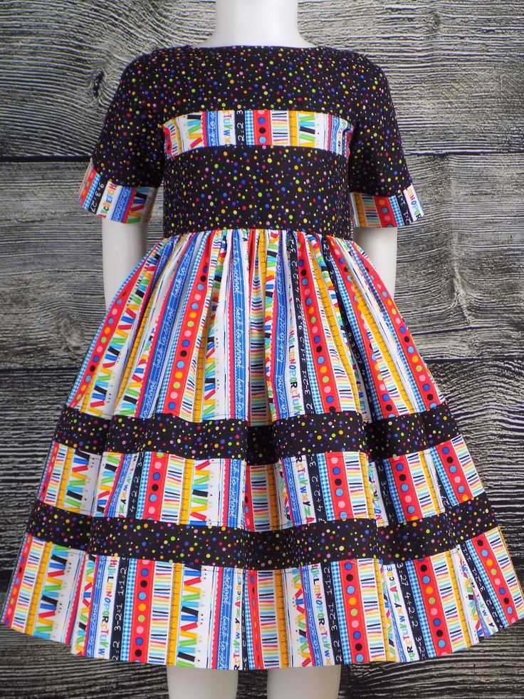 "Colorful and Fun ABC School Dress with Short Sleeves and Back Buttons Girls School Dress with Lined Bodice and Full Skirt is perfect for Back to School. Featuring ABC's, Pencils, Ruler with a Unique Stripe Insert Toddler dress can be a great Pre School Outfit with a matching Hair Bow or Bloomers. Short Sleeves with Border Trim perfect for year around wear. My Boutique Dresses are Handmade with all Cotton Fabric Handmade Made in the USA by me! ---------------------------------------------------- Multicolor Cotton School Dress, Playful Multicolor Dresses For School, Fitted Multicolor Dress For School, Multicolor Fitted Dress For School, Fitted Multicolor Dresses For School, Playful Multicolor School Dresses, Cotton School Dresses With Buttons, Multicolor Cotton Dresses With Buttons, Kitenge Outfits