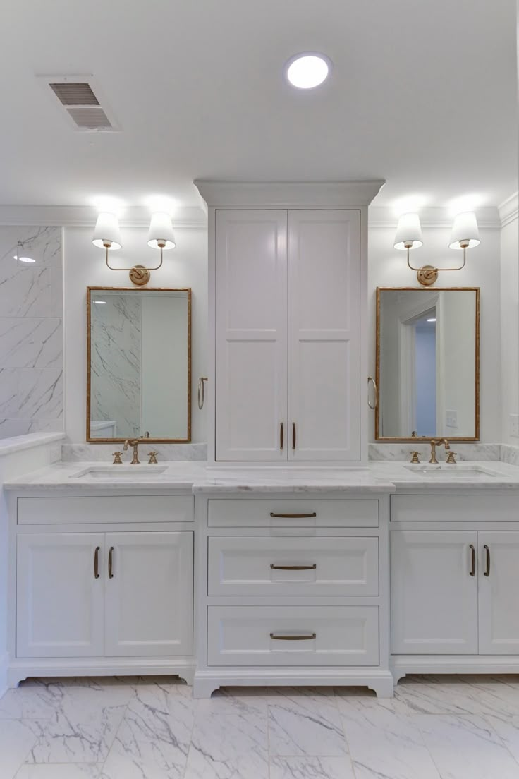 a large bathroom with two sinks and mirrors